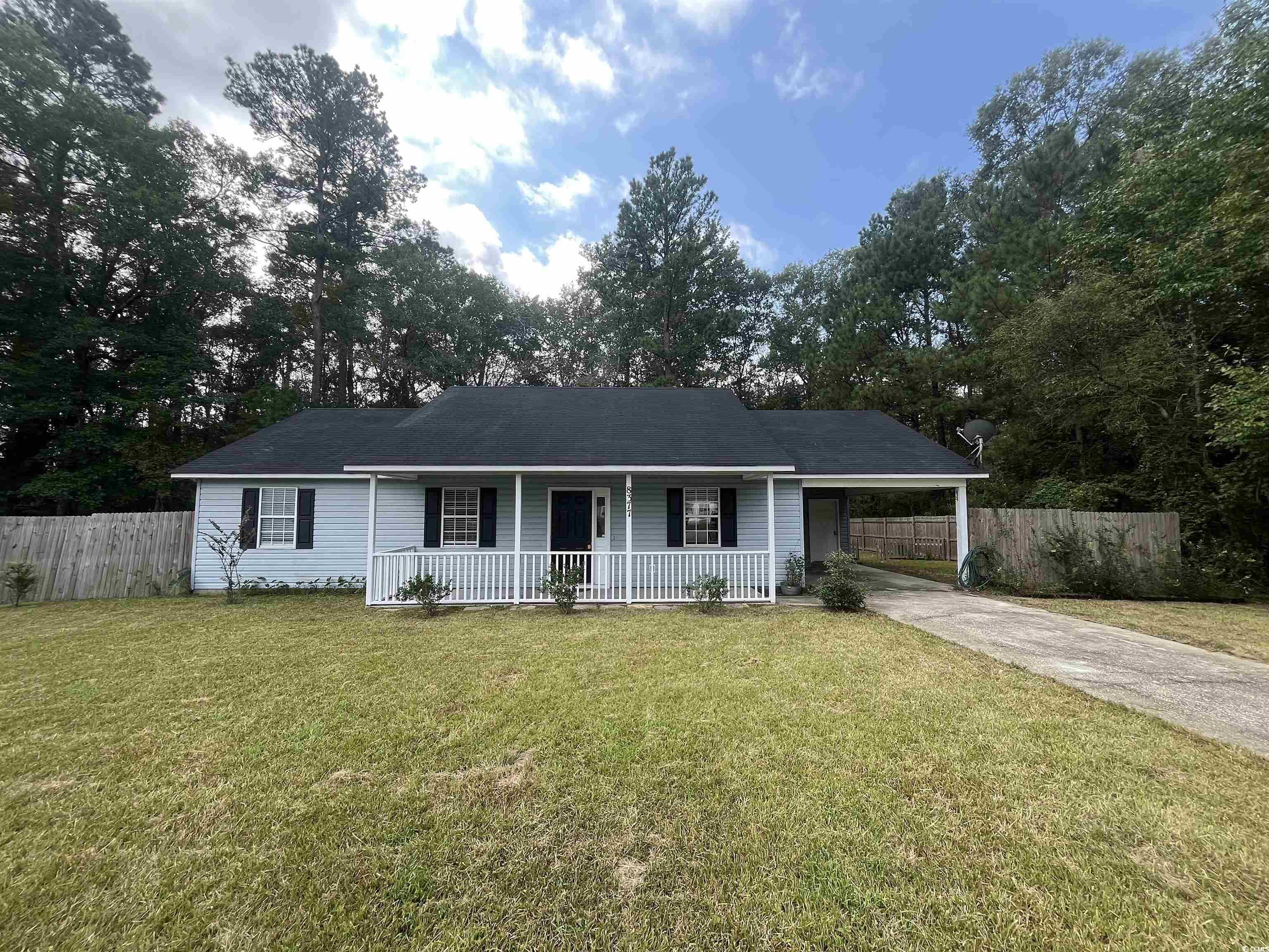 Single story home featuring a front yard and cover