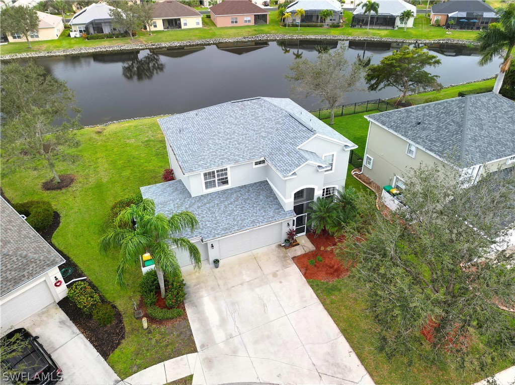 an aerial view of a house with a lake view