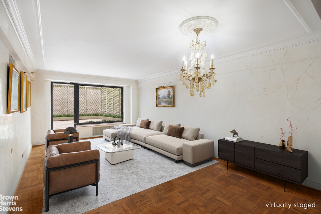 a living room with furniture and a chandelier