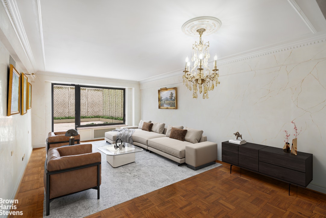 a living room with furniture and a chandelier