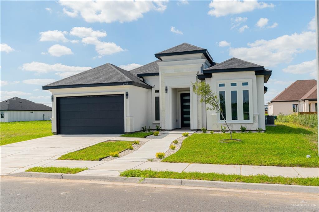 a view of a house with a swimming pool and a yard