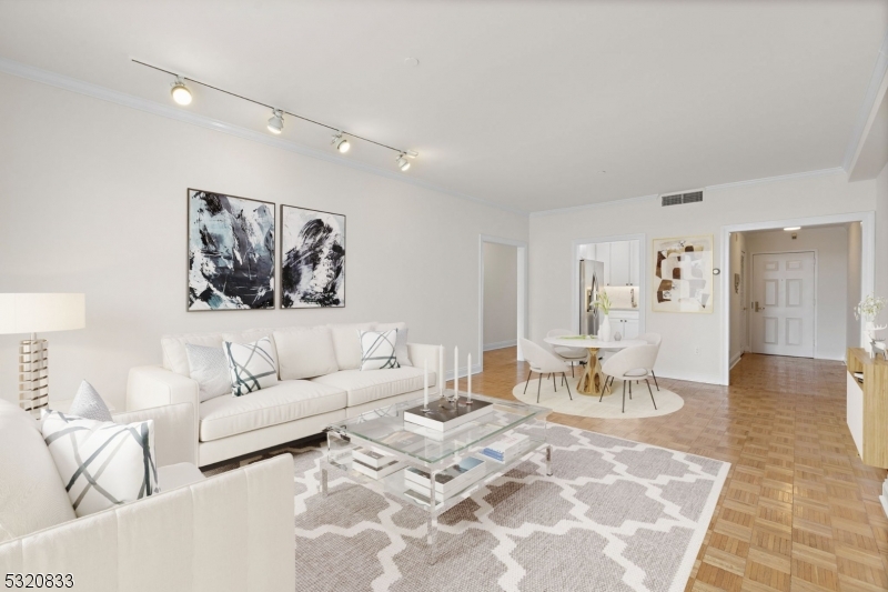 a living room with furniture and view of kitchen