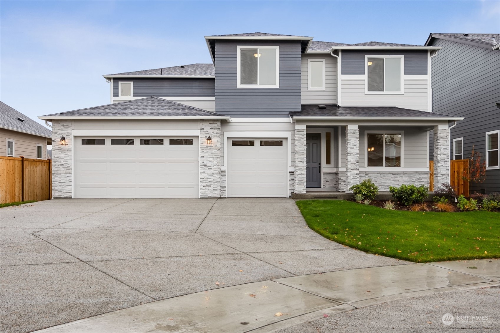 a front view of a house with a yard and garage