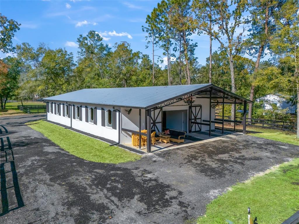 a view of a house with backyard and sitting area