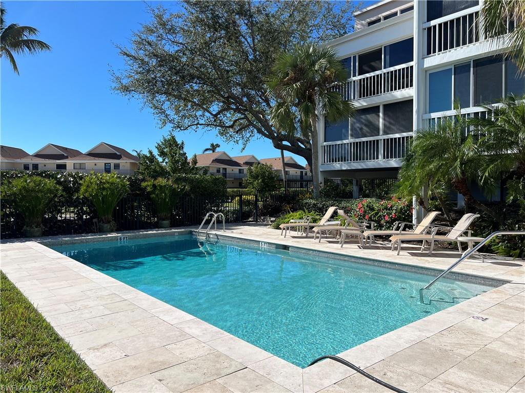 a view of a house with swimming pool and sitting area