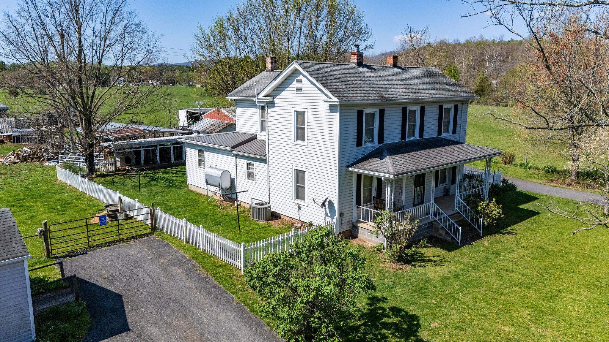 a aerial view of a house with yard and green space