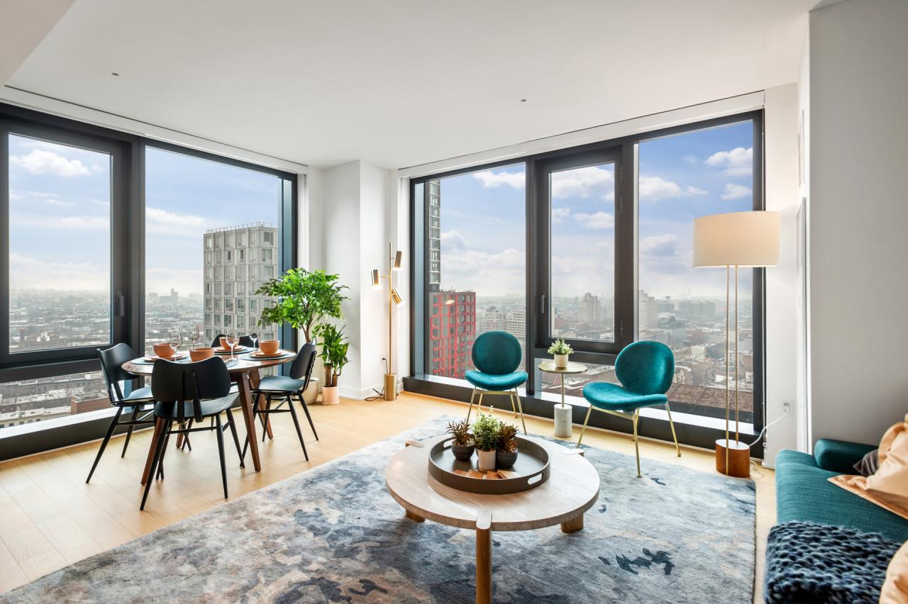 a dining room with furniture and a floor to ceiling window