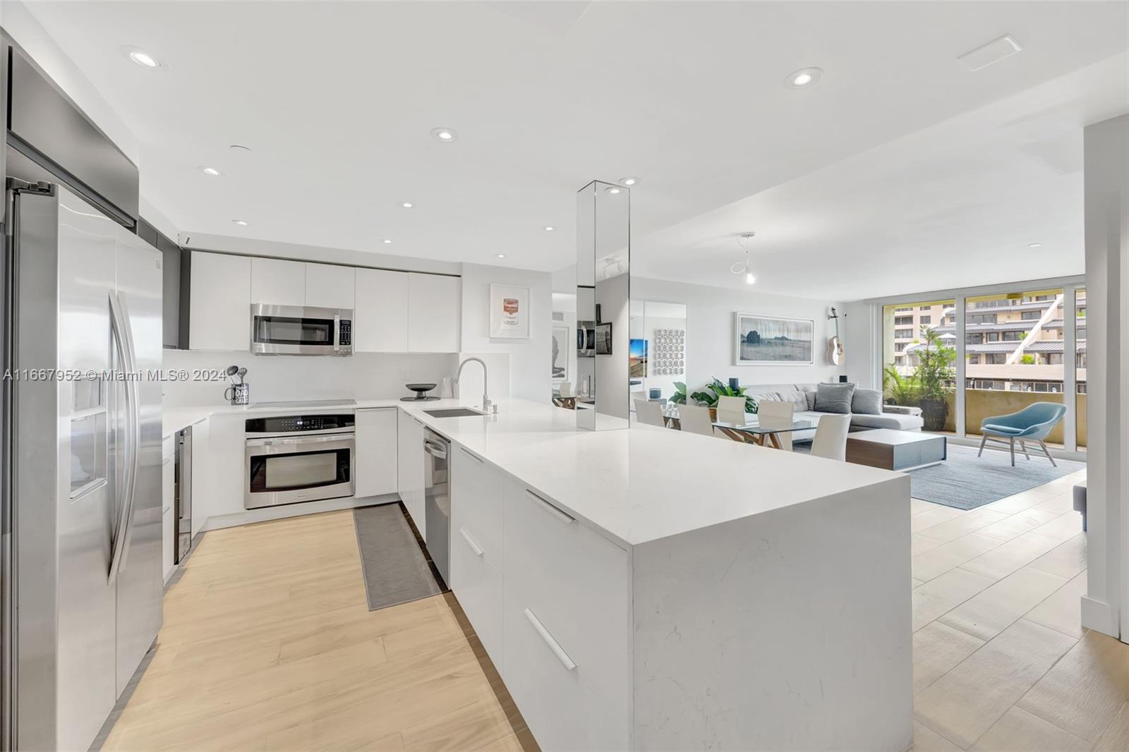 a large white kitchen with a stove a sink and a refrigerator