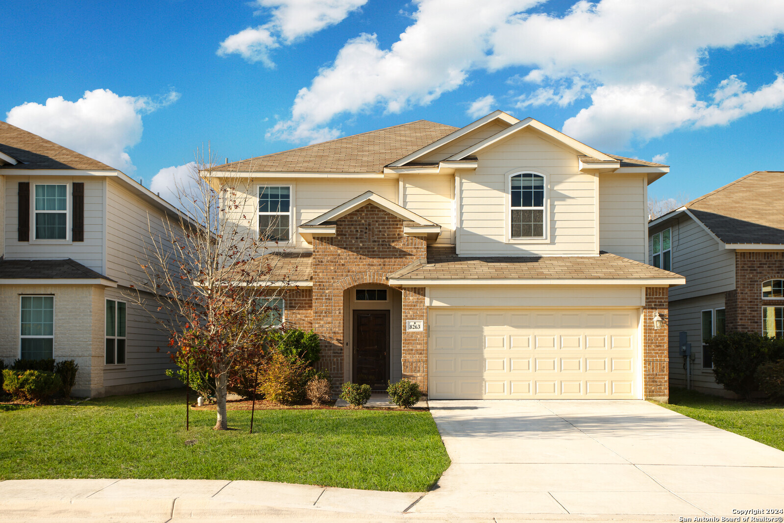 a front view of a house with a yard and garage