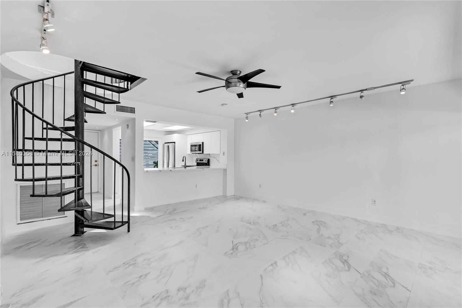 a view of entryway and hall with a chandelier