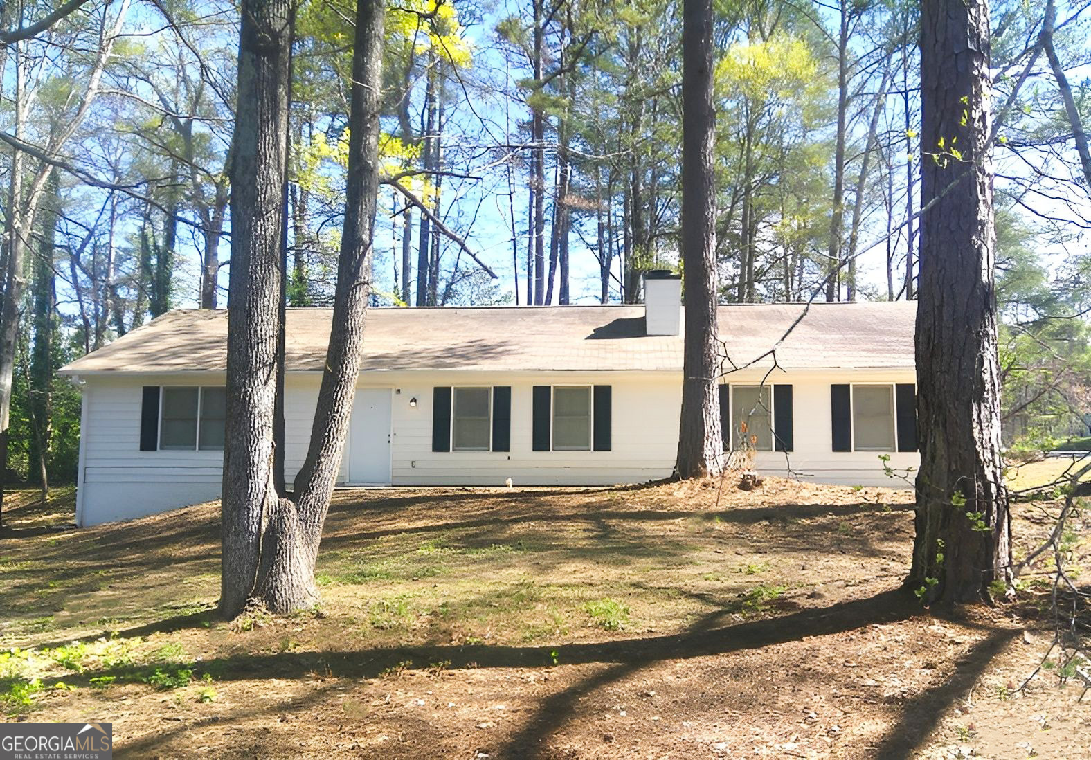 a house that has a tree in front of it