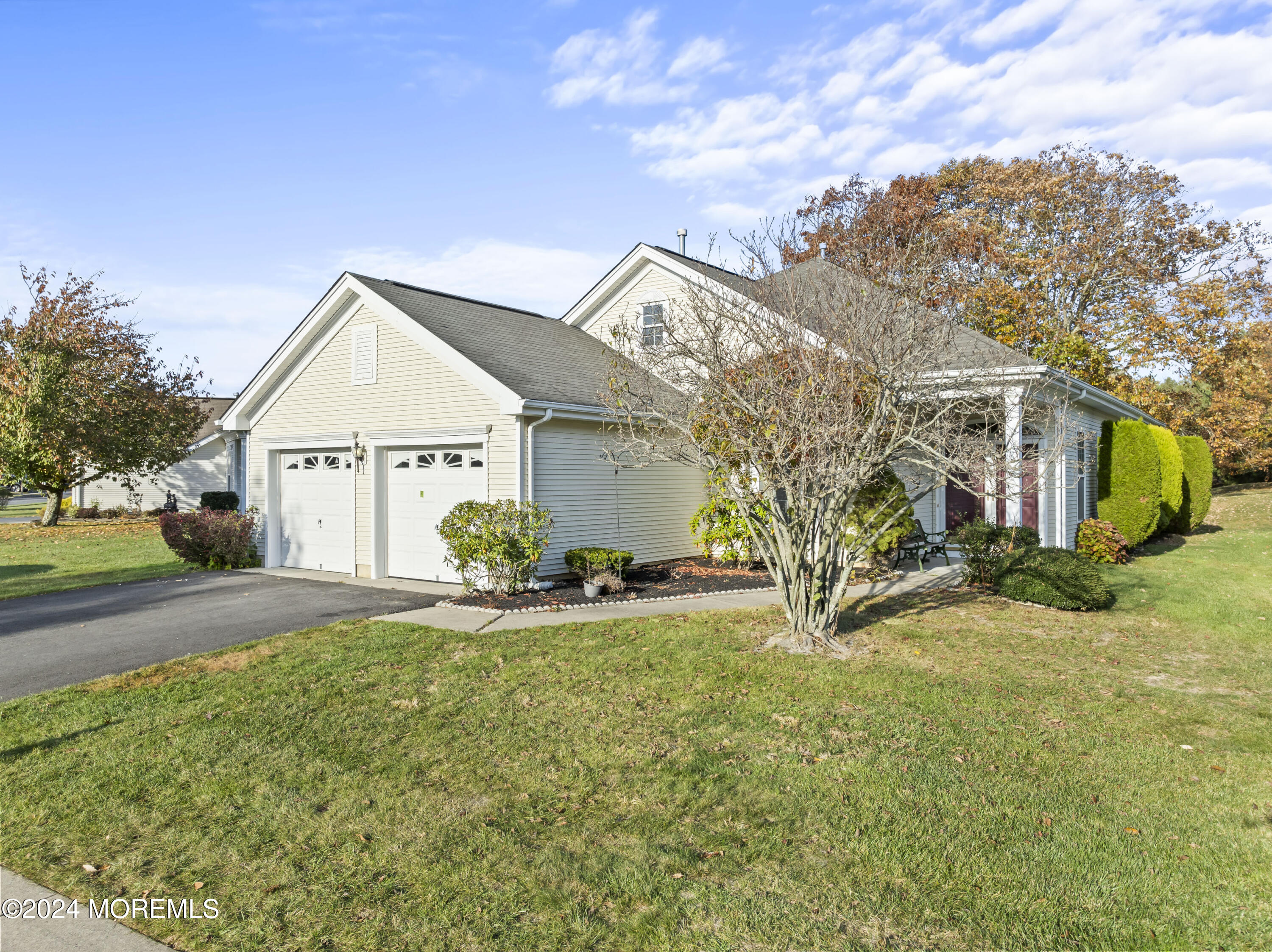 a view of a house with a yard and garage