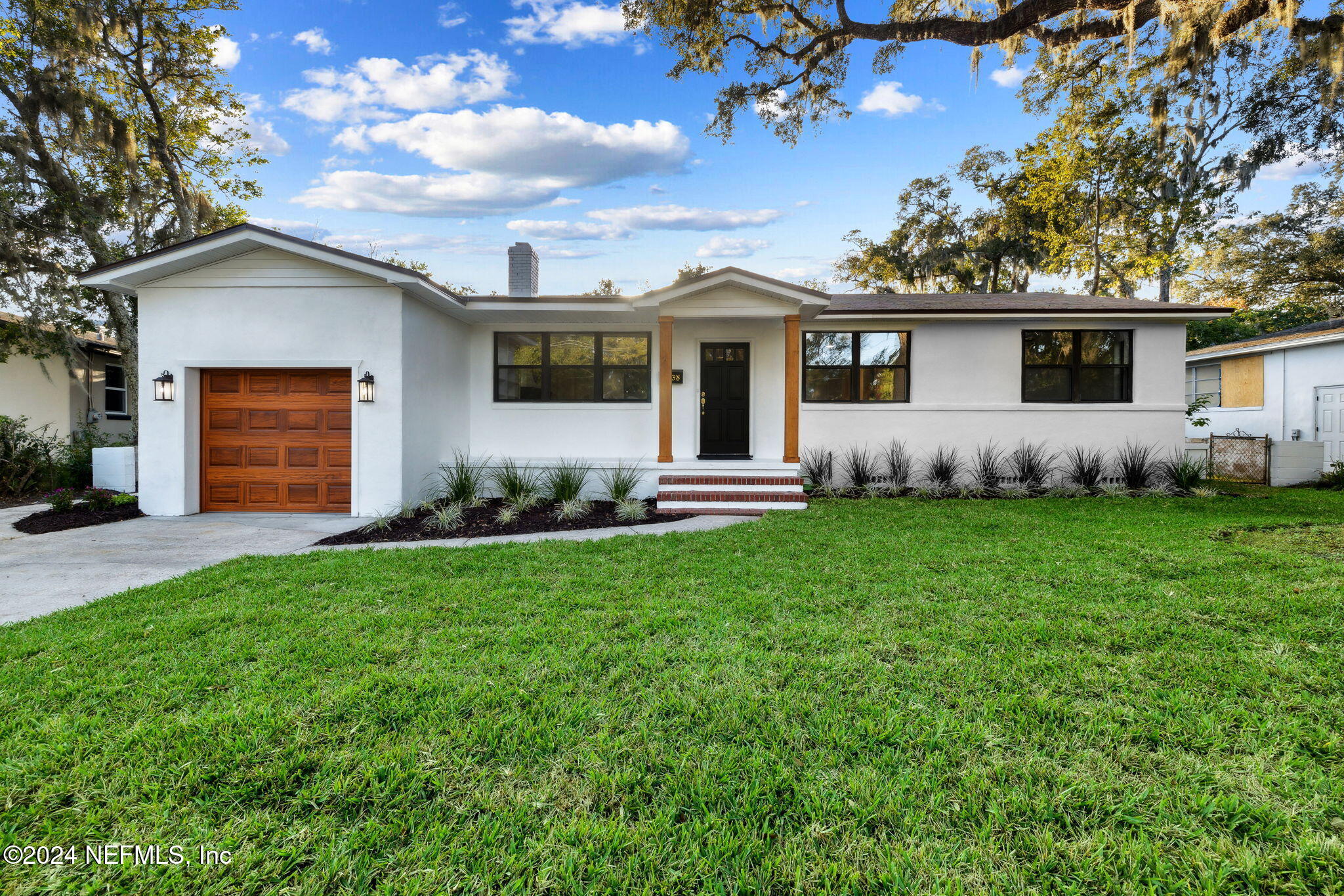 a front view of house with yard and outdoor seating