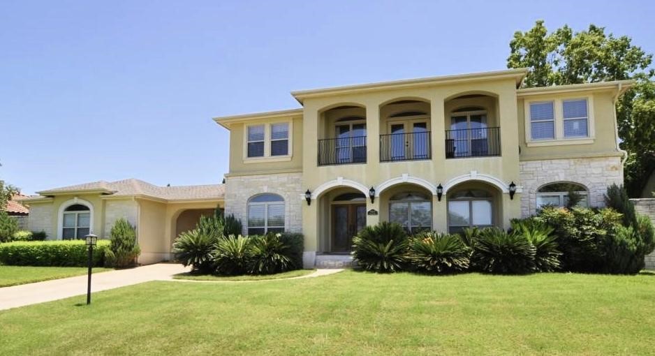 a front view of a house with a garden