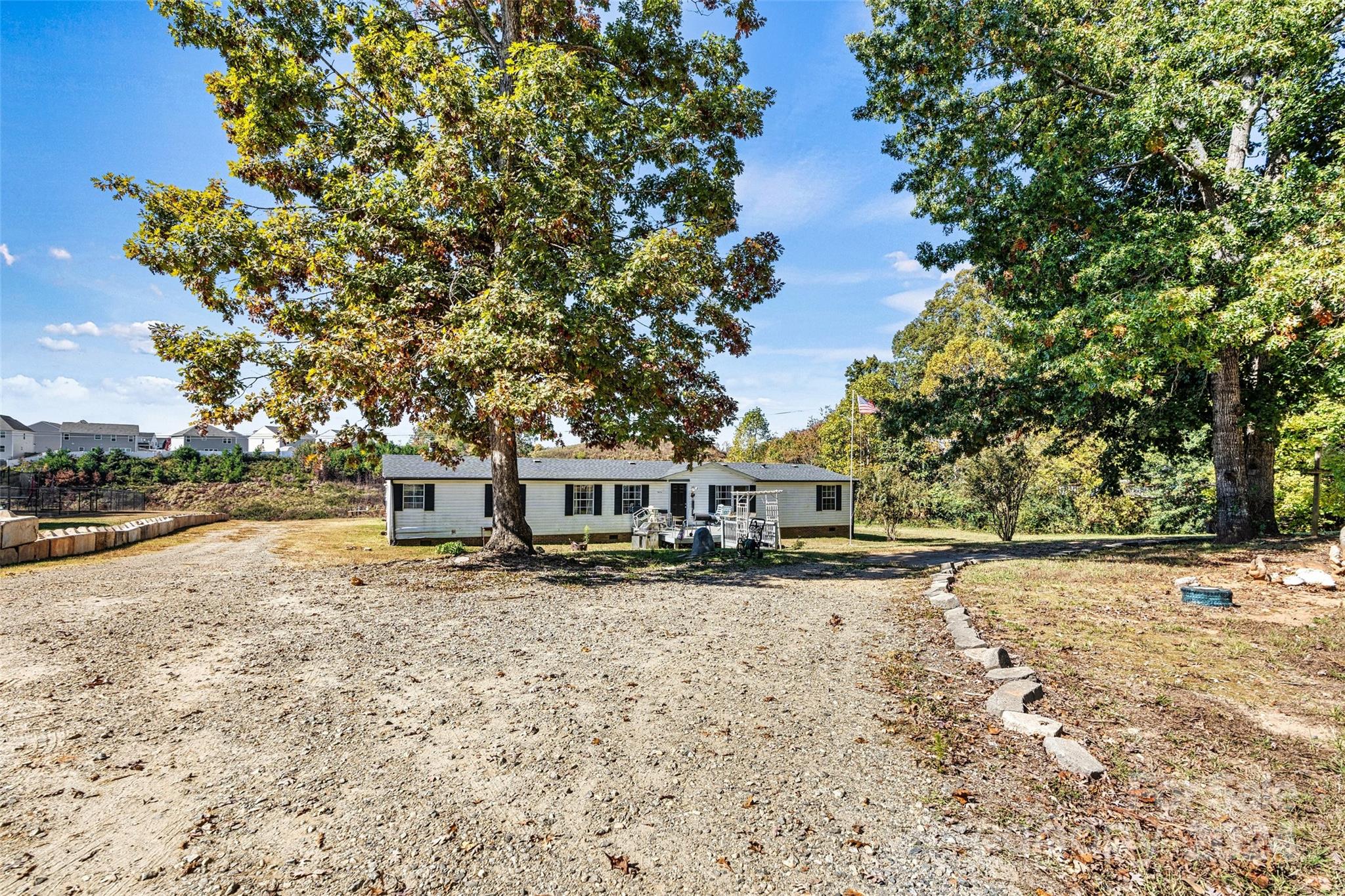 a front view of a house with a yard and trees