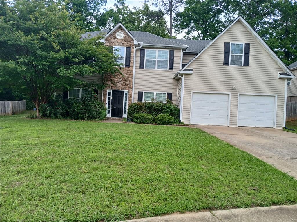 a view of a yard in front view of a house