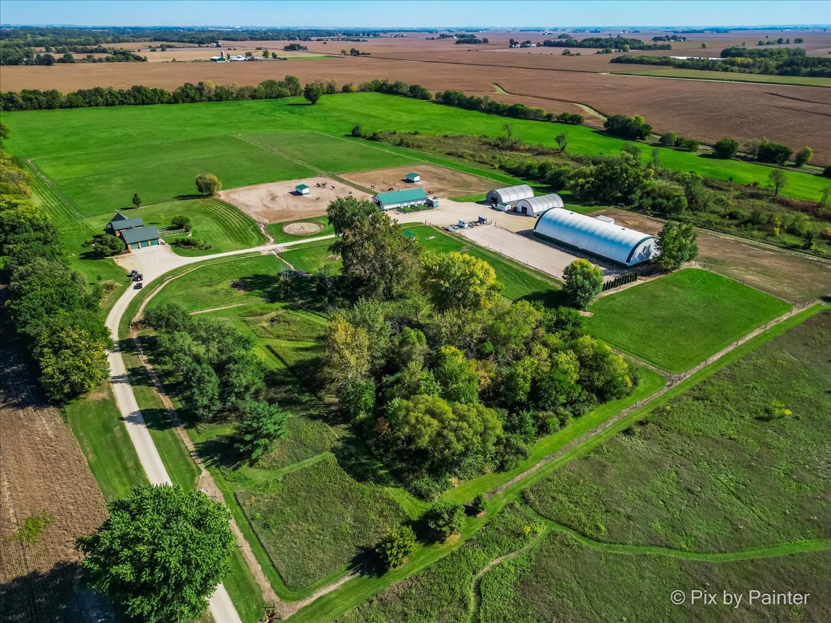 an aerial view of a house with outdoor space and lake view