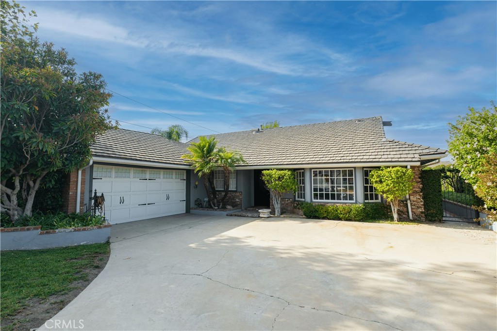 a view of house with outdoor space and a yard