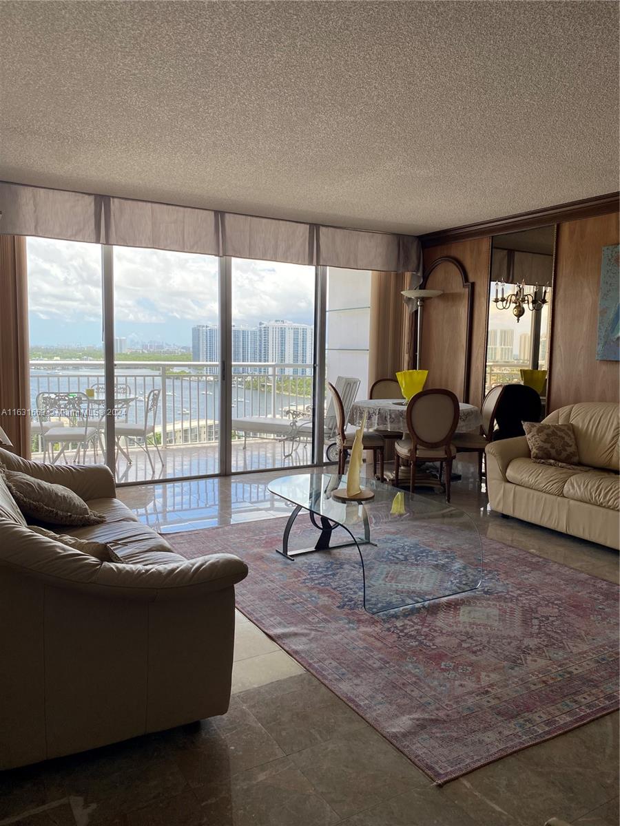 a living room with furniture and large windows