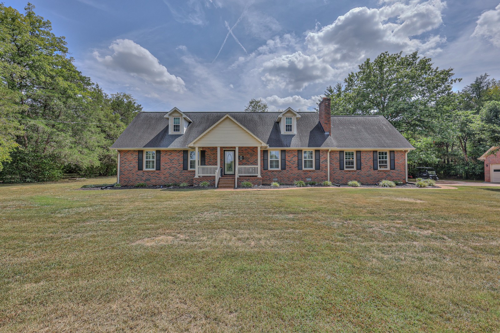 a front view of a house with a garden