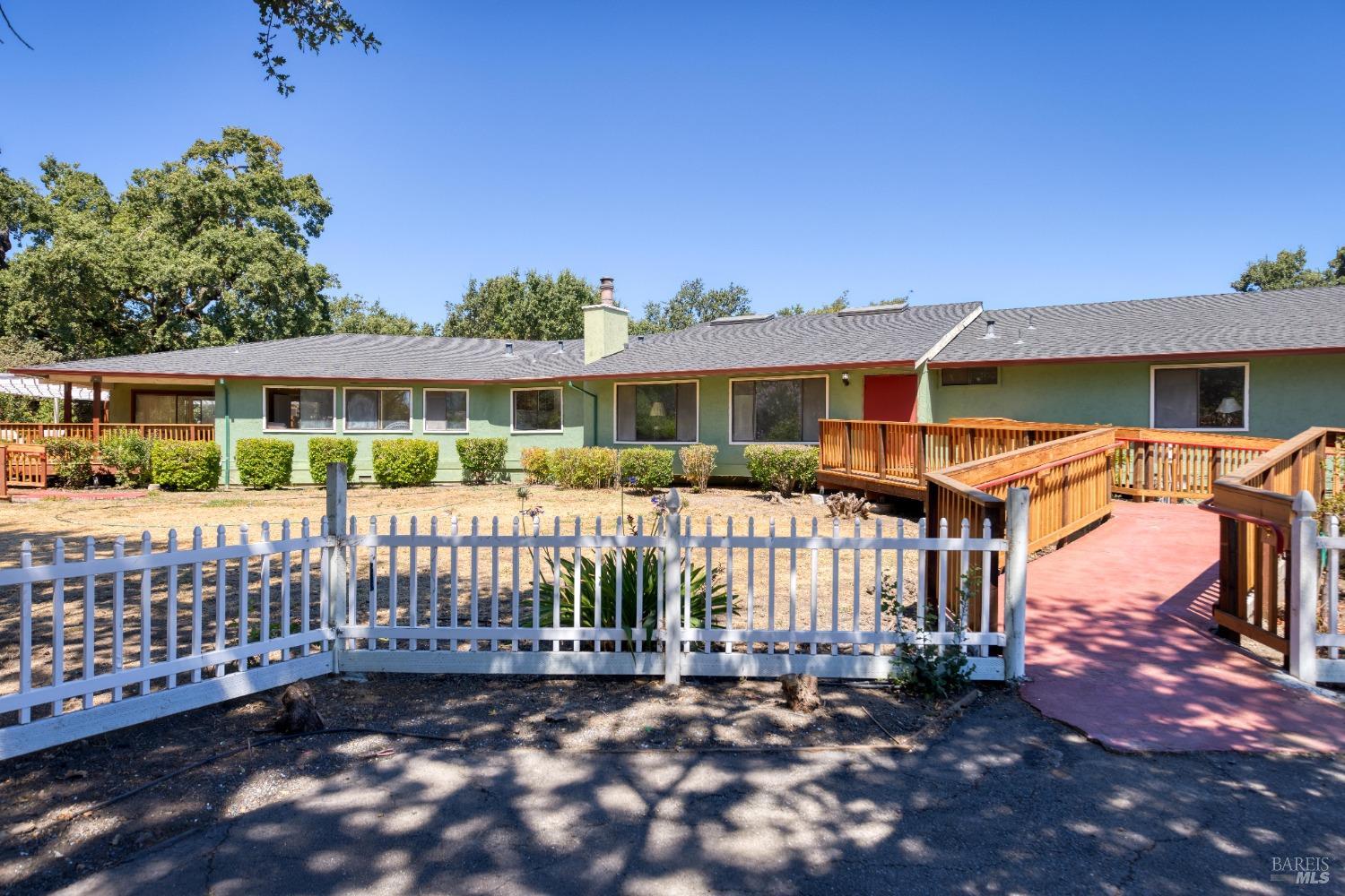 a view of a house with a wooden deck