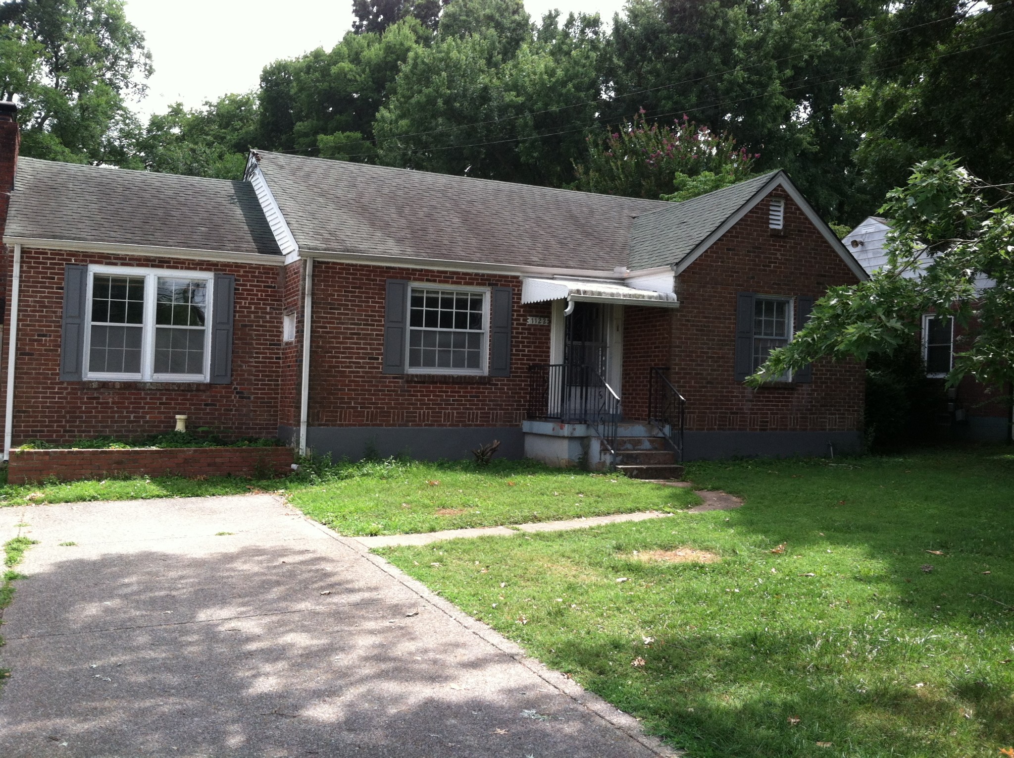 a aerial view of a house next to a yard