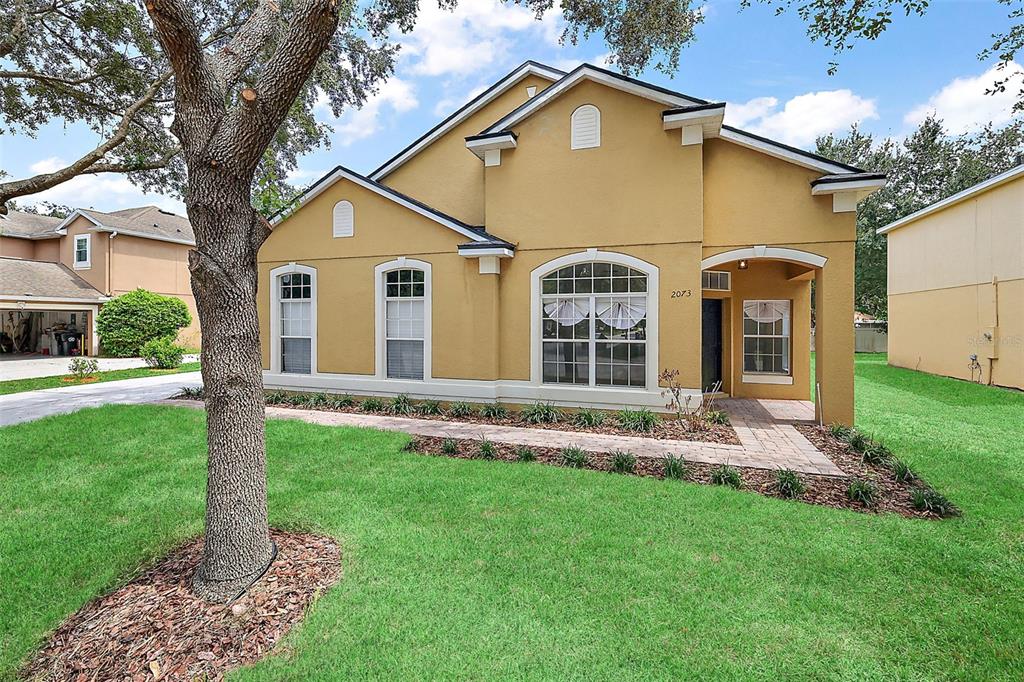 a front view of a house with a yard