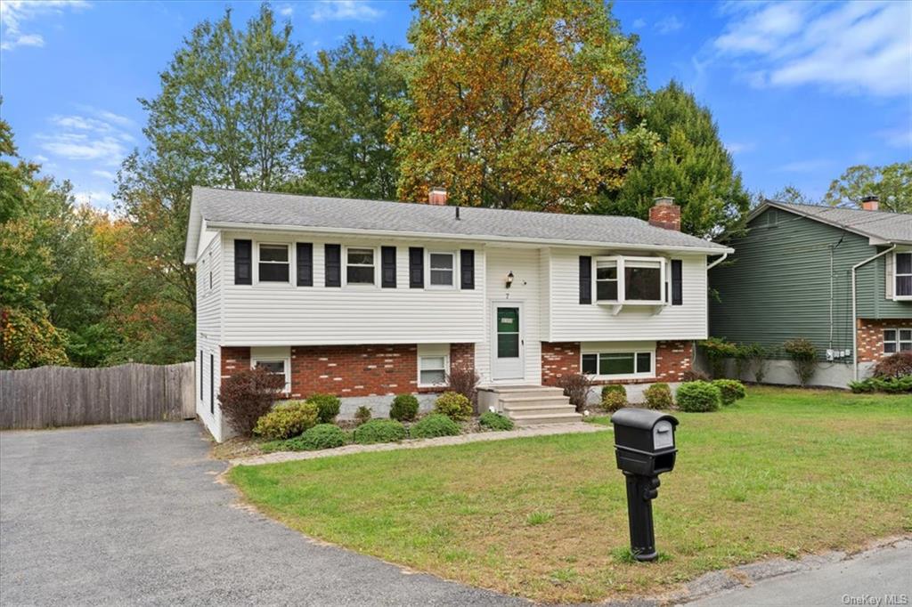 a front view of a house with garden and sitting area