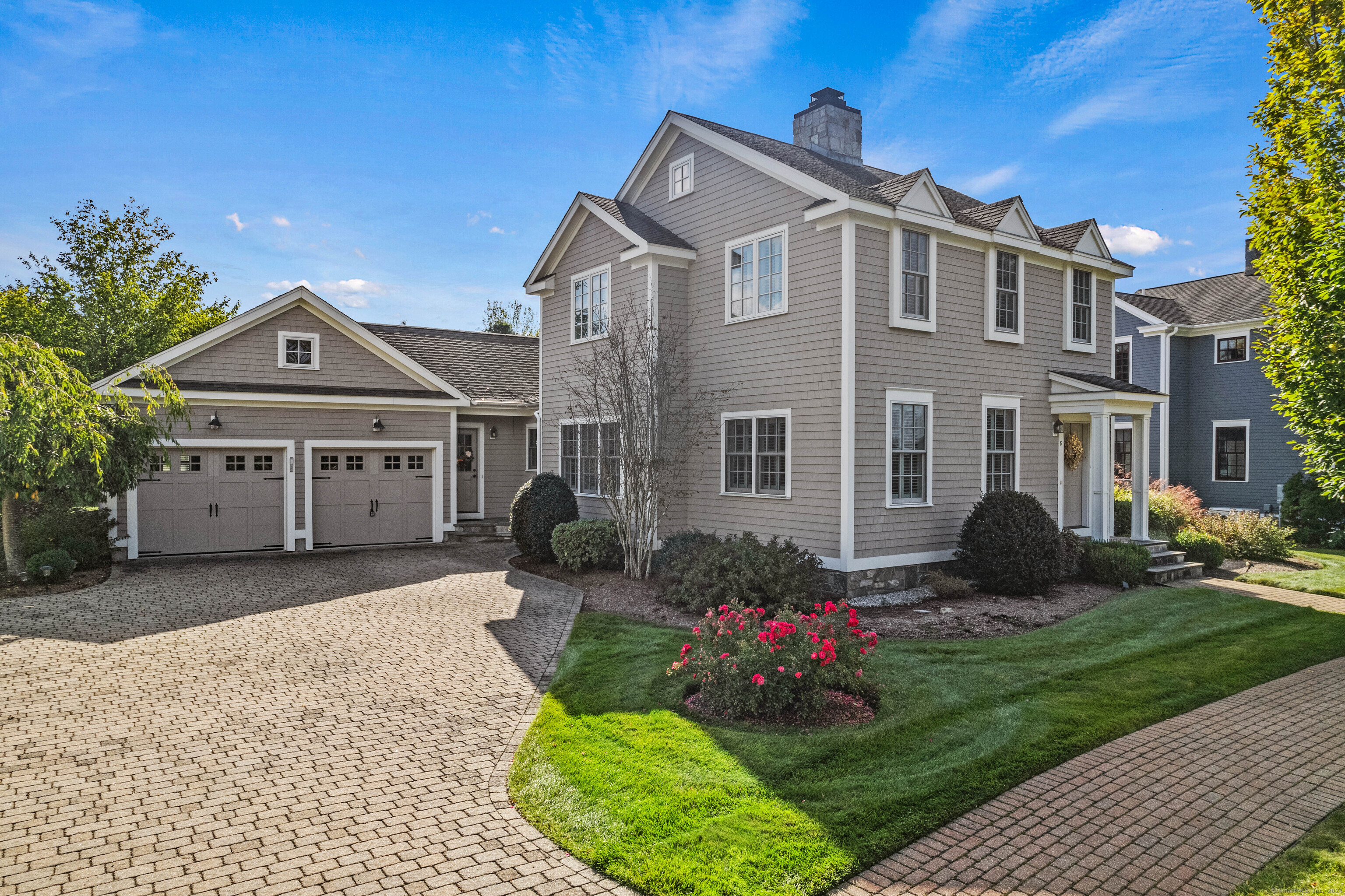 a front view of a house with a garden