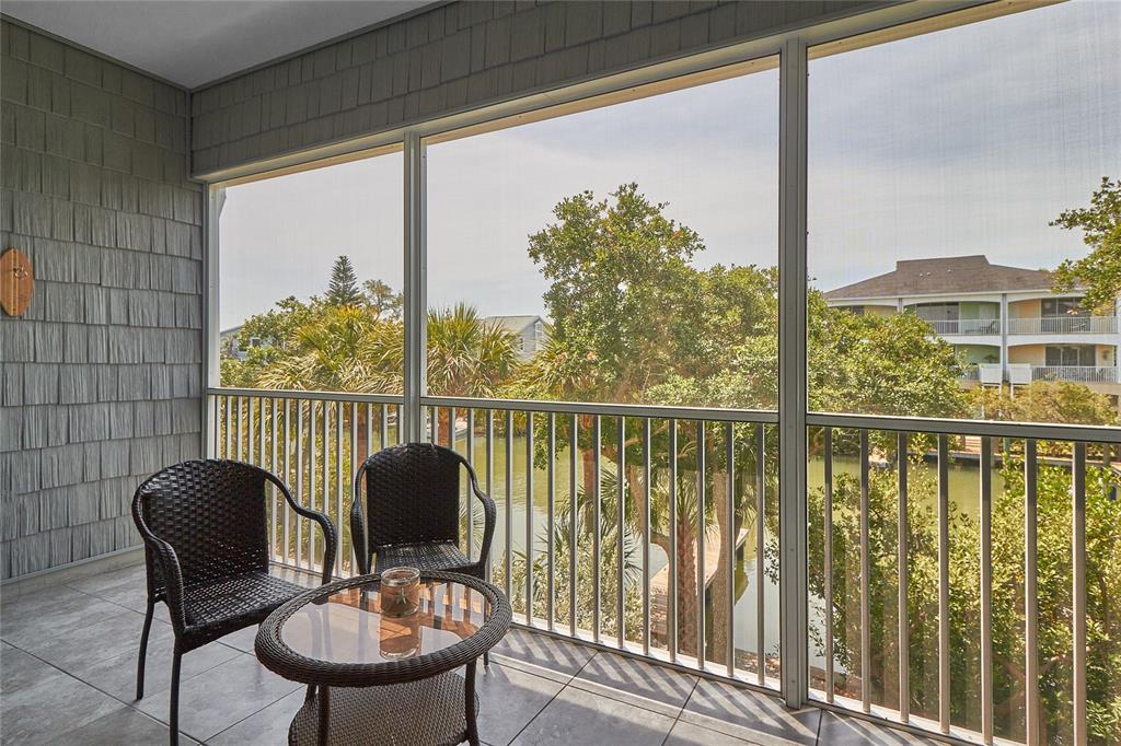 a view of a balcony with chair and glass door