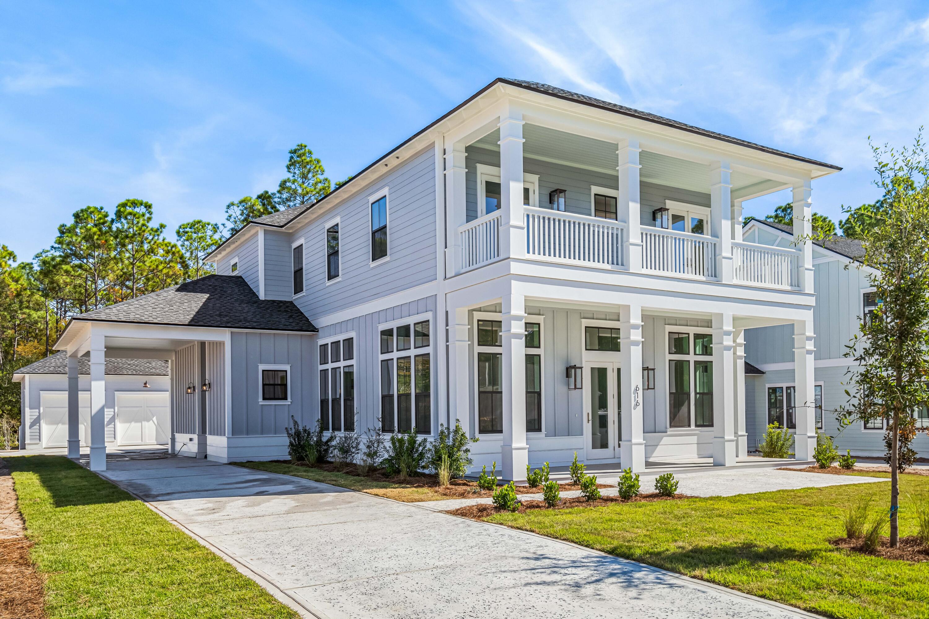 a front view of a house with garden and porch