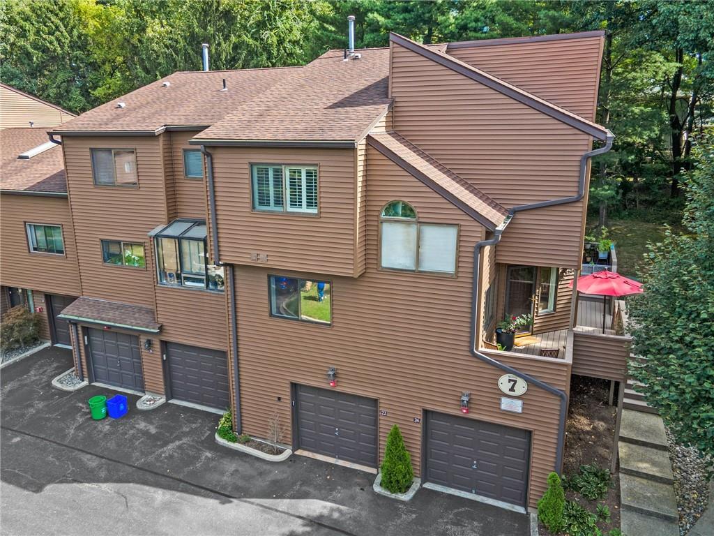 View of side of property with a garage