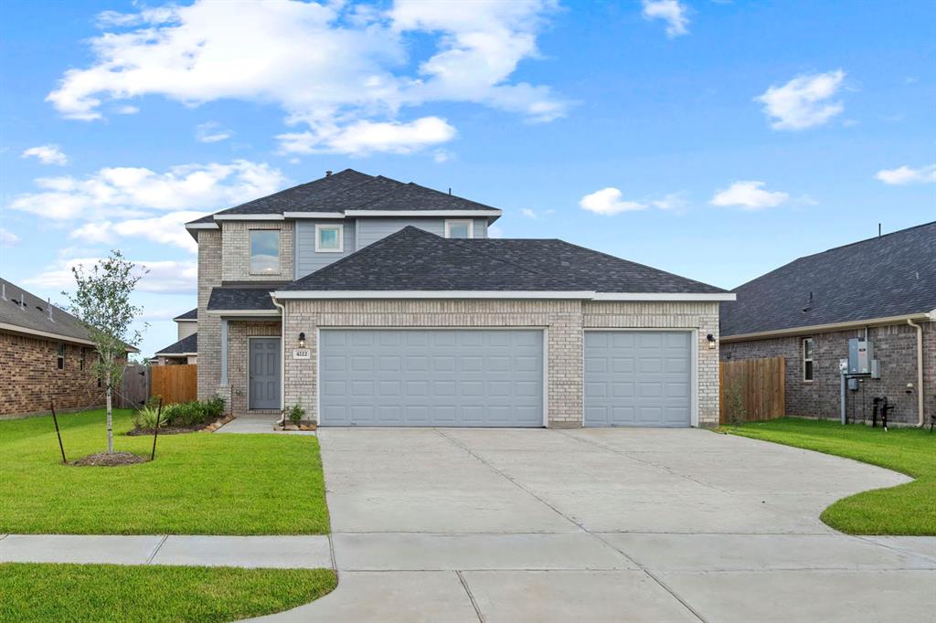 a front view of a house with a garden and yard