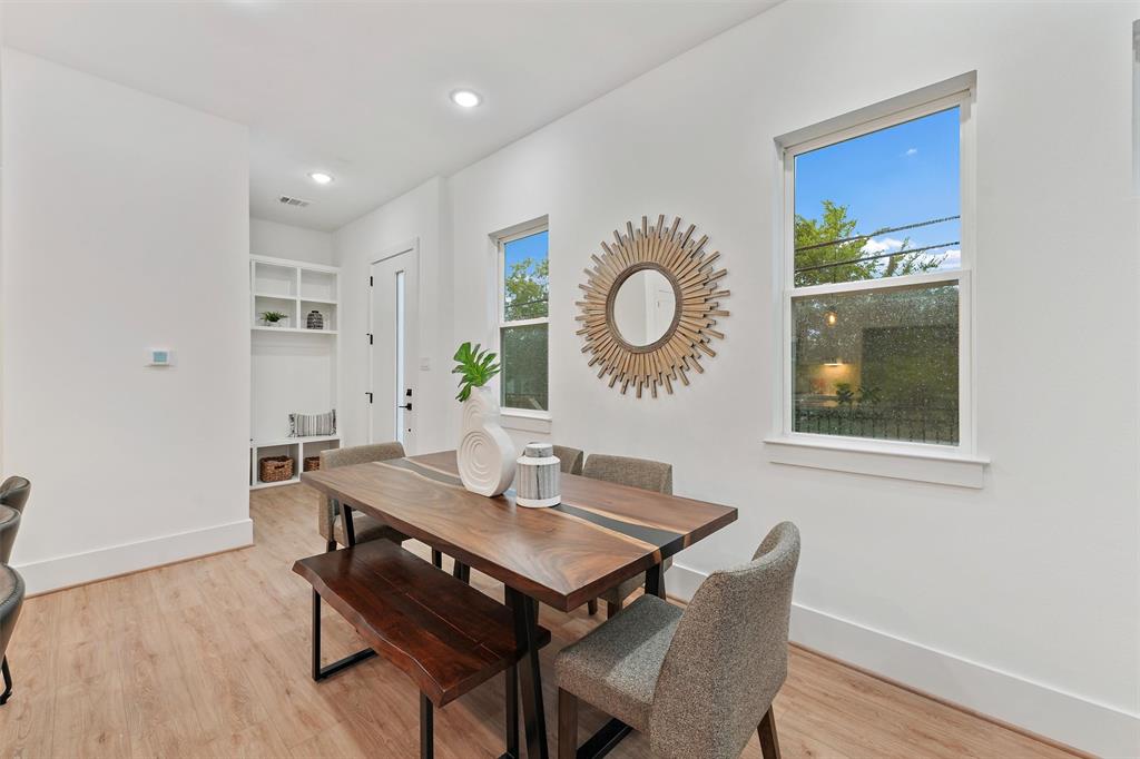 a view of a dining room with furniture and wooden floor