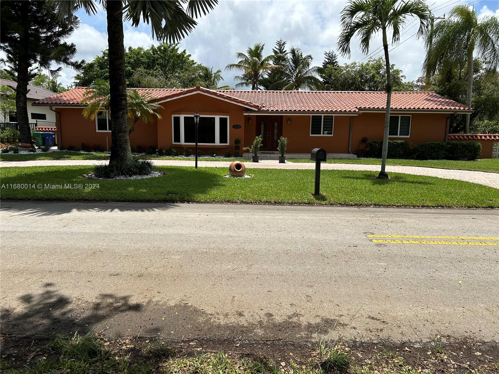 a front view of house with yard and green space