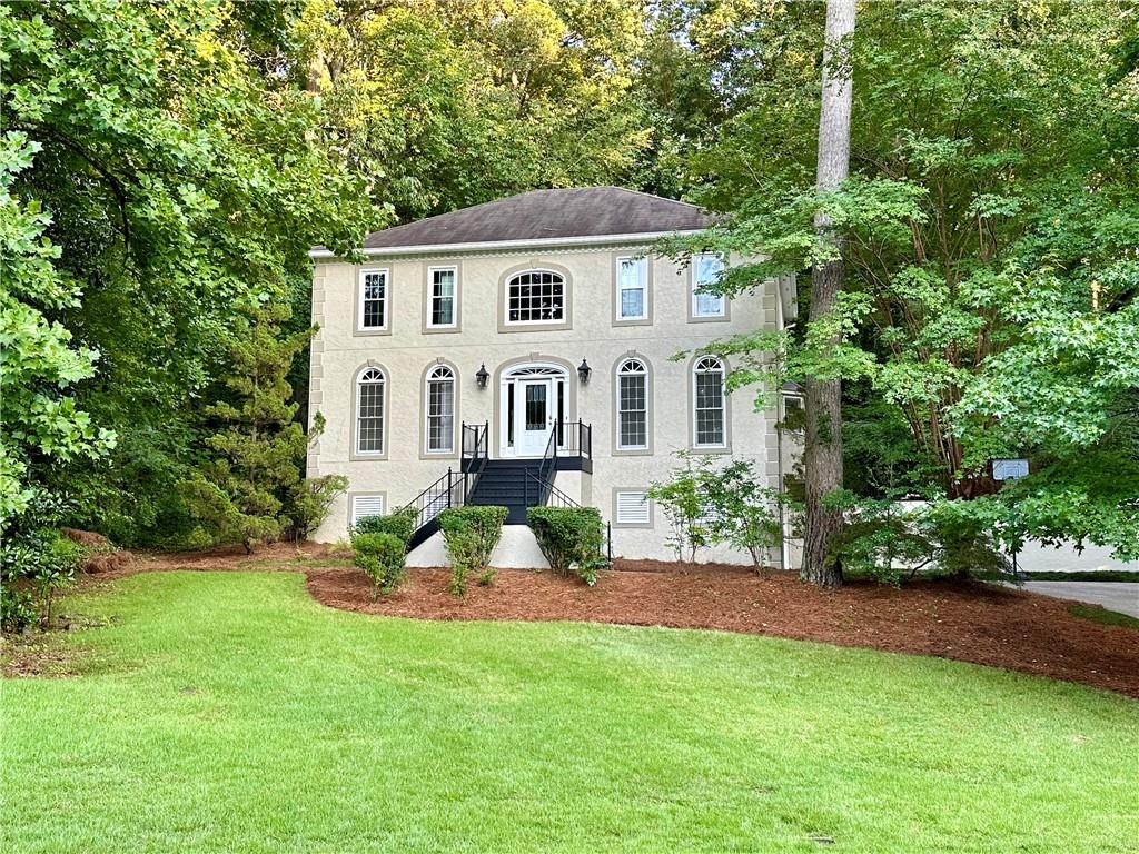 a front view of a house with a garden