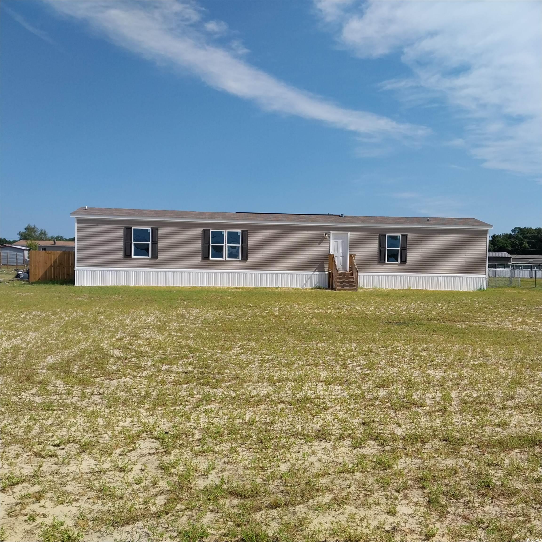 View of front of home featuring a front lawn