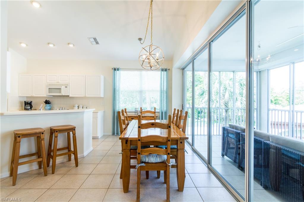 a dining room with furniture a chandelier and fireplace