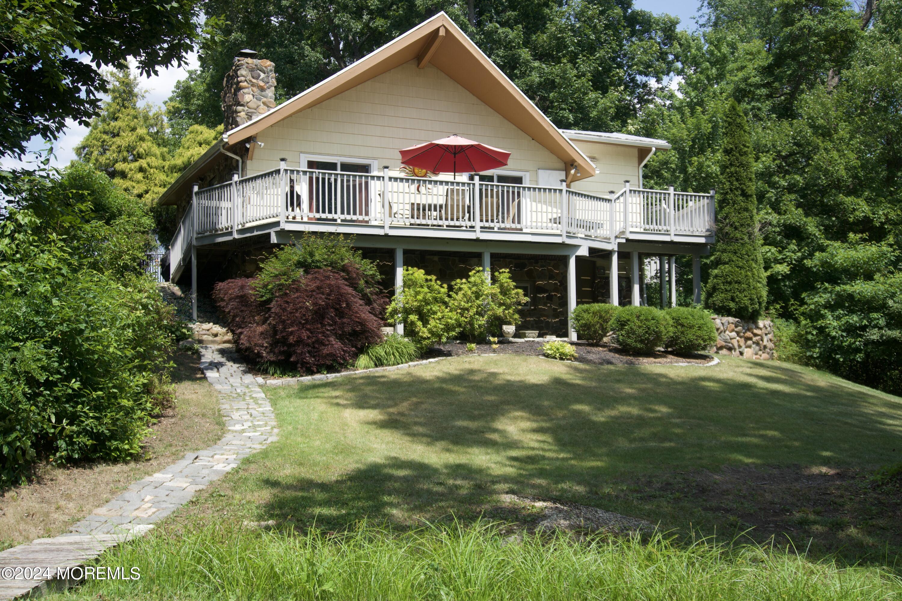 a view of a house with a yard and potted plants