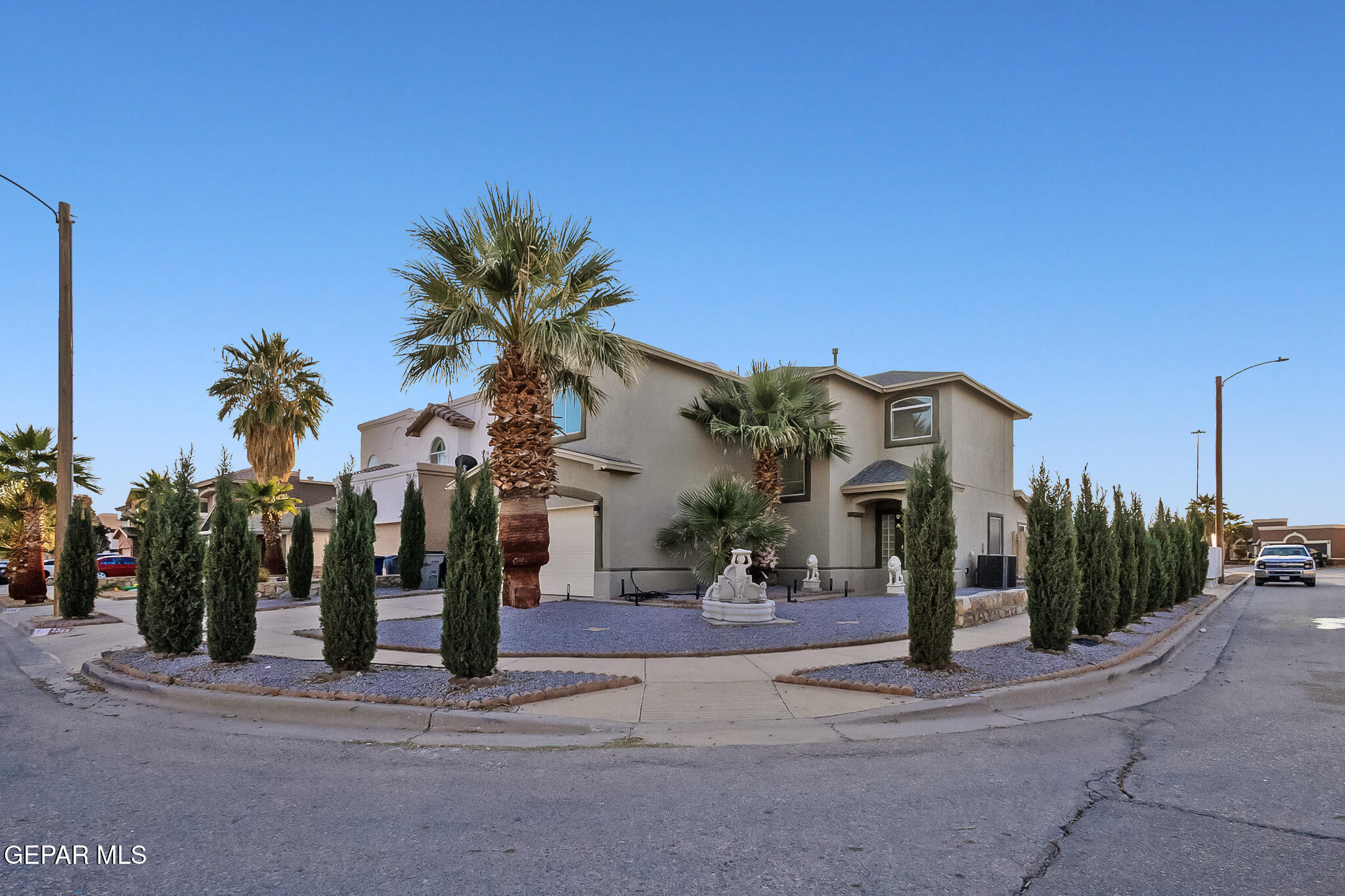 a palm tree sitting in front of a building