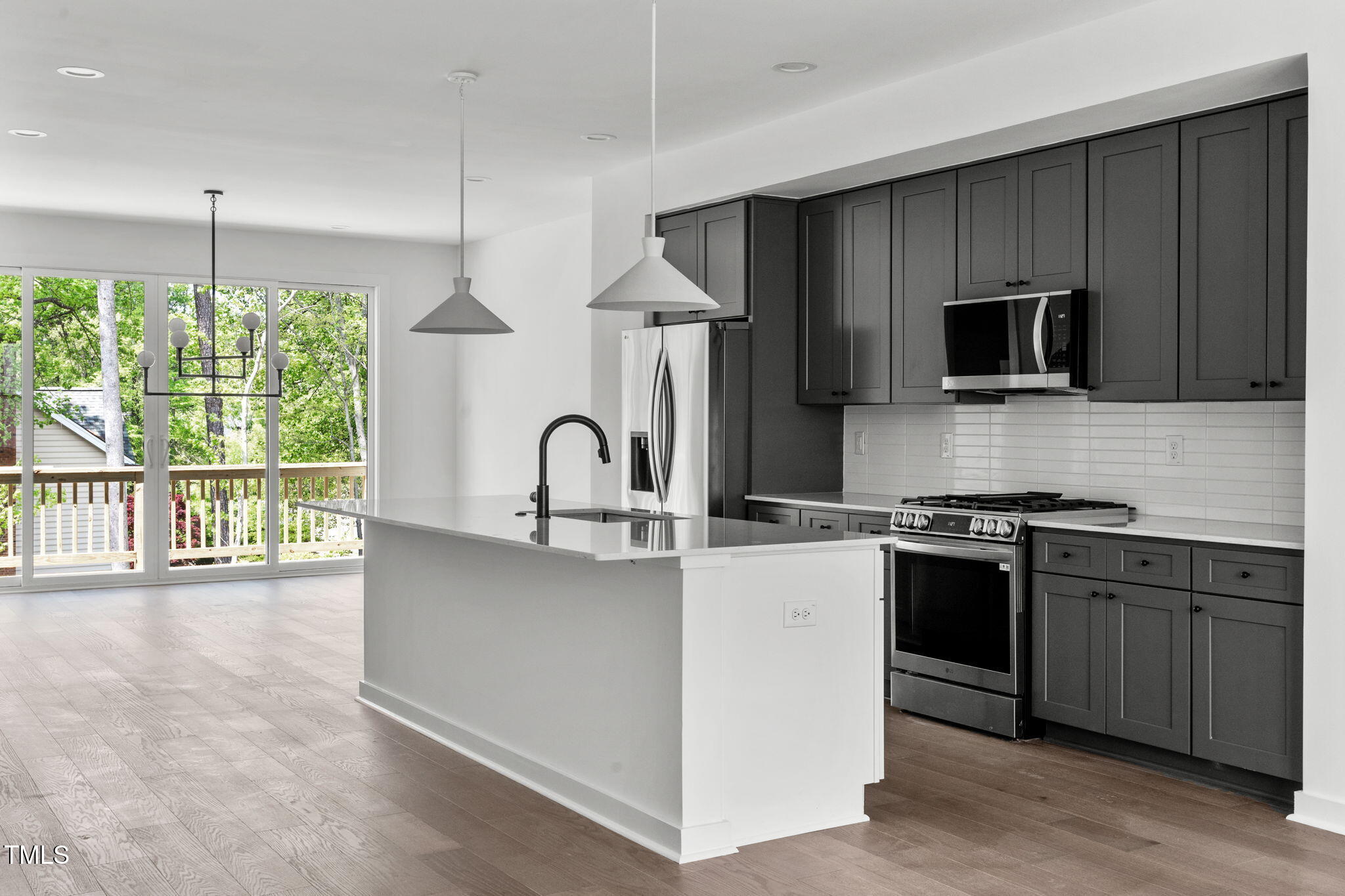 a kitchen with stainless steel appliances a stove sink and microwave