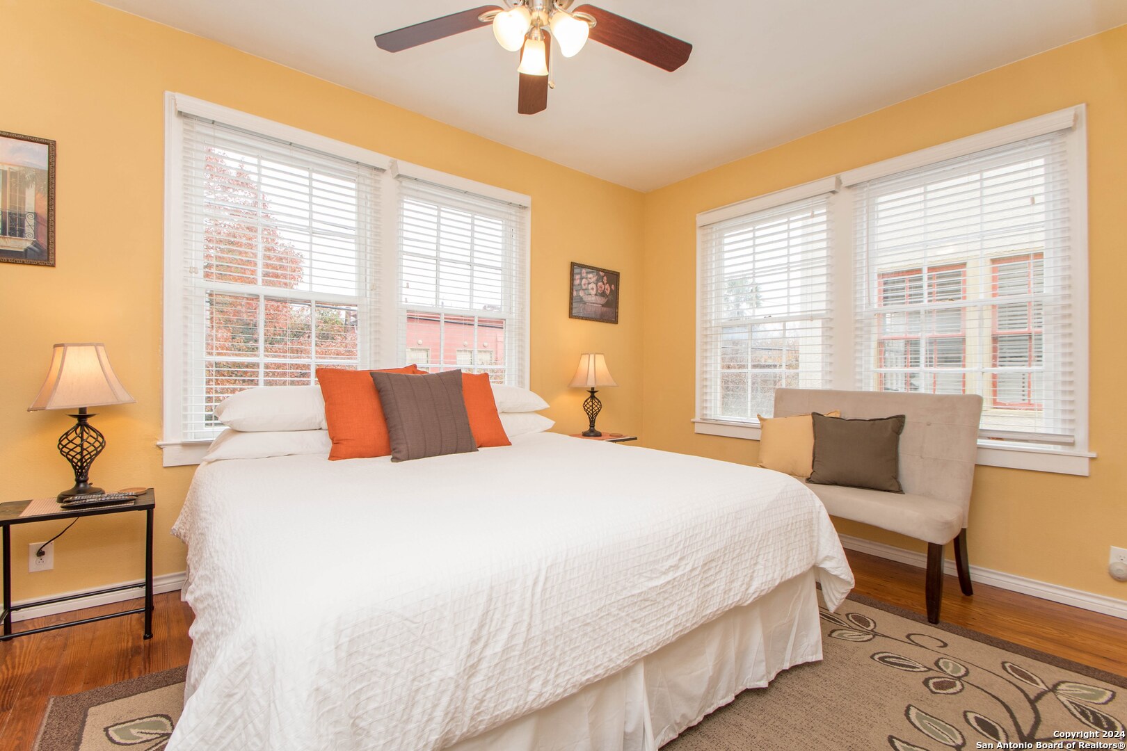 a bedroom with a bed and a large window