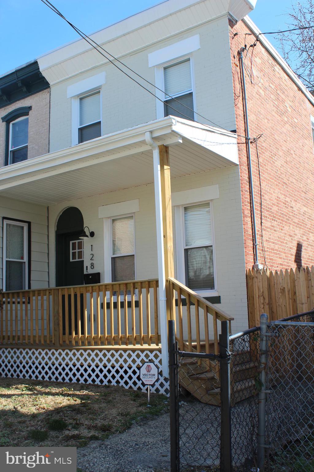 a view of a house with a wooden fence