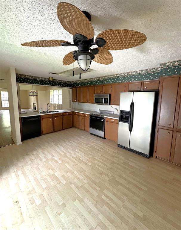 a kitchen with stainless steel appliances granite countertop a sink and a stove