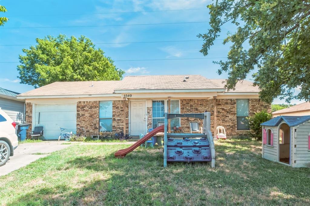 a view of a house with a yard and furniture