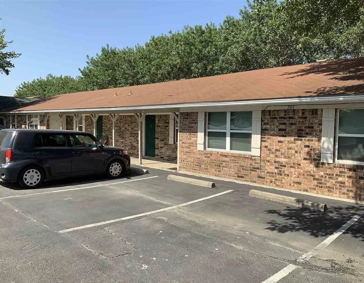 a view of a car parked in front of a house