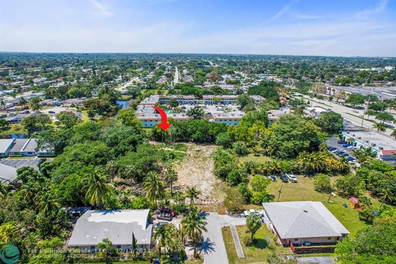 an aerial view of a houses with a yard