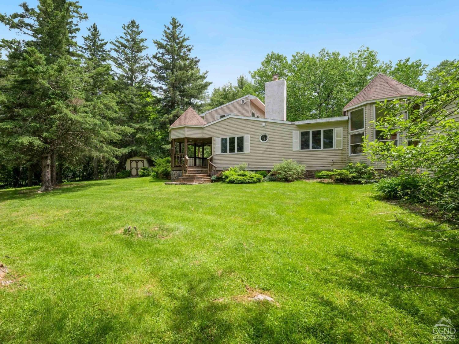 a front view of a house with yard and green space