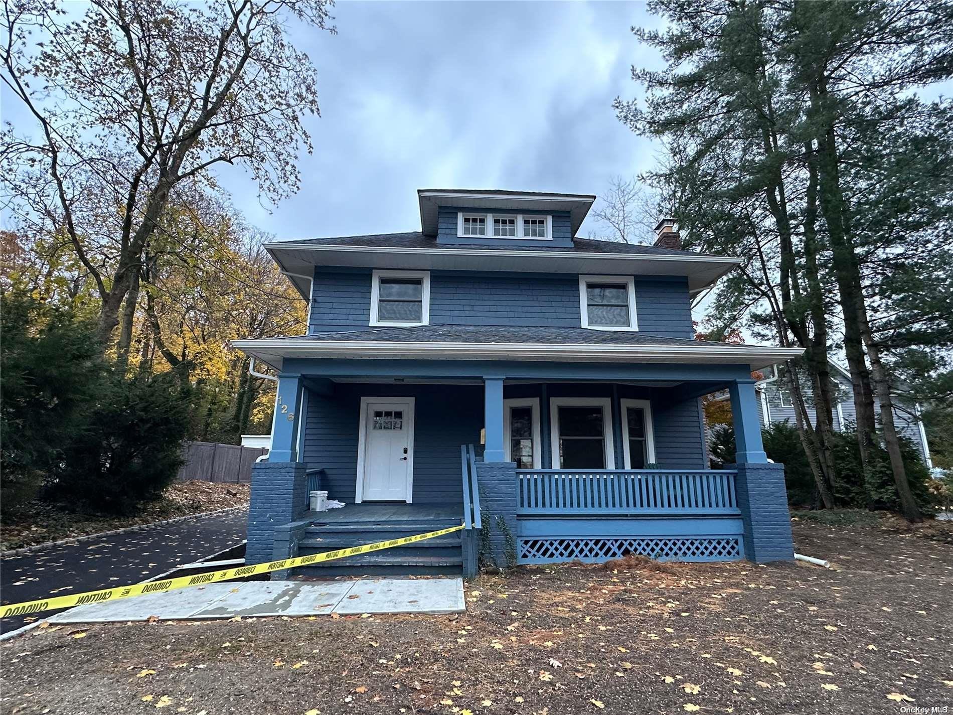 a house that has a tree in front of the house