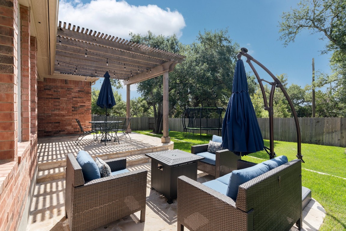 a view of backyard with outdoor seating and plants